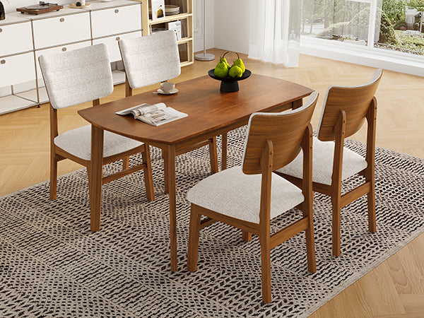 Angled view of 4-seat farmhouse dining table set with upholstered chairs, ideal for compact dining spaces.