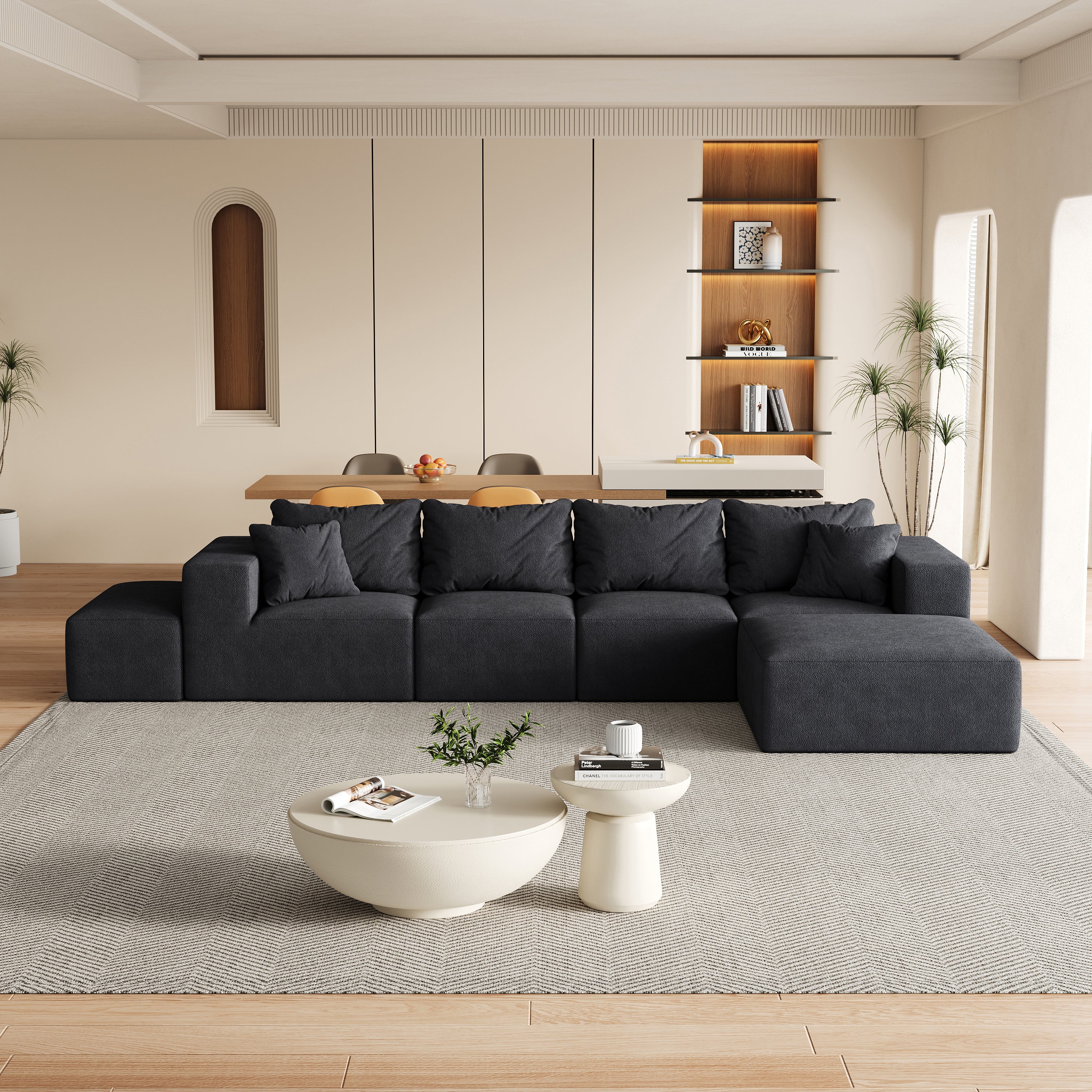Modern charcoal modular L-shaped sectional sofa with plush cushions, set in a contemporary living room on a rug.