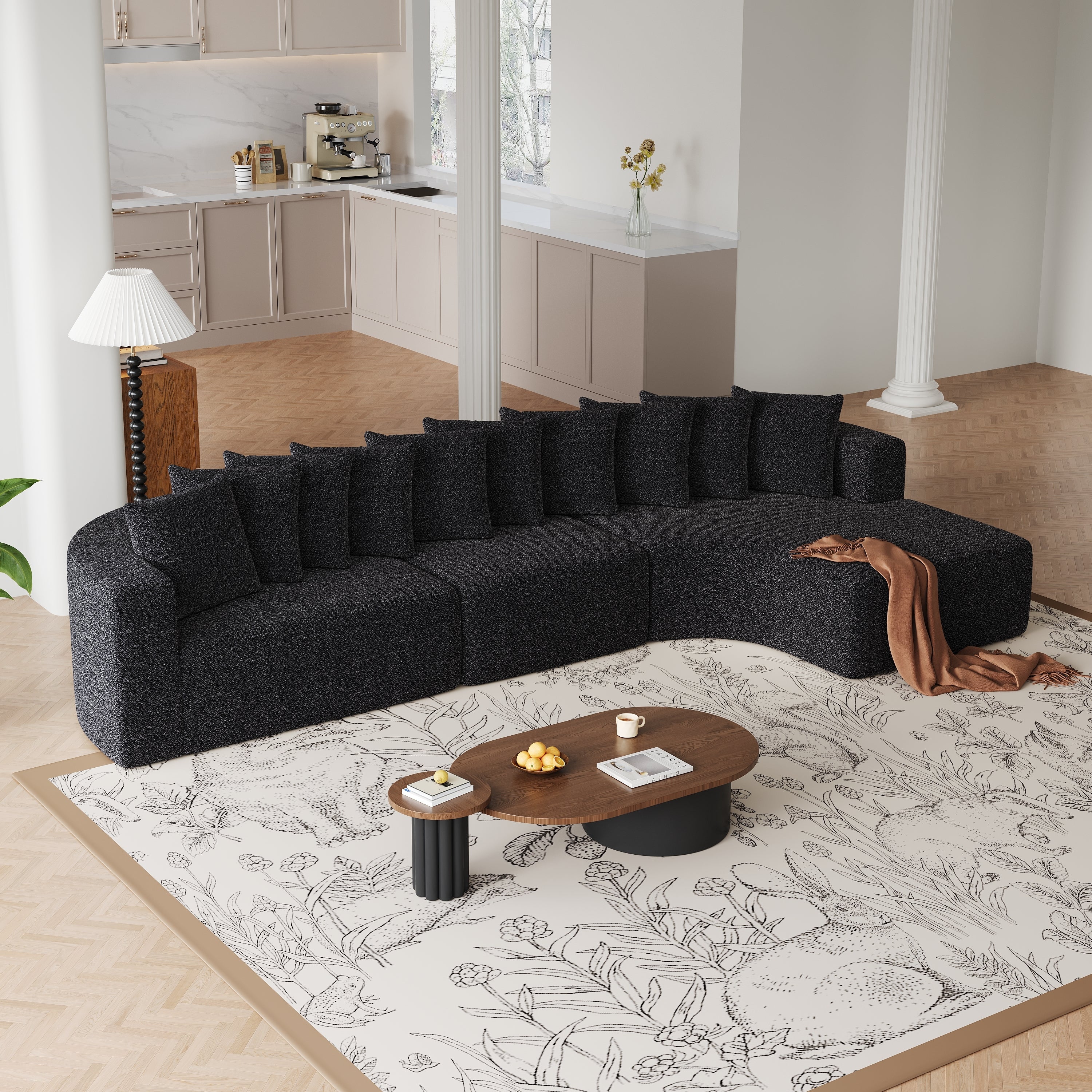 Chenille Sectional Sofa - Modular L-Shaped Sofa in black with curved design and 10 pillows, placed in a bright living room with wood flooring.