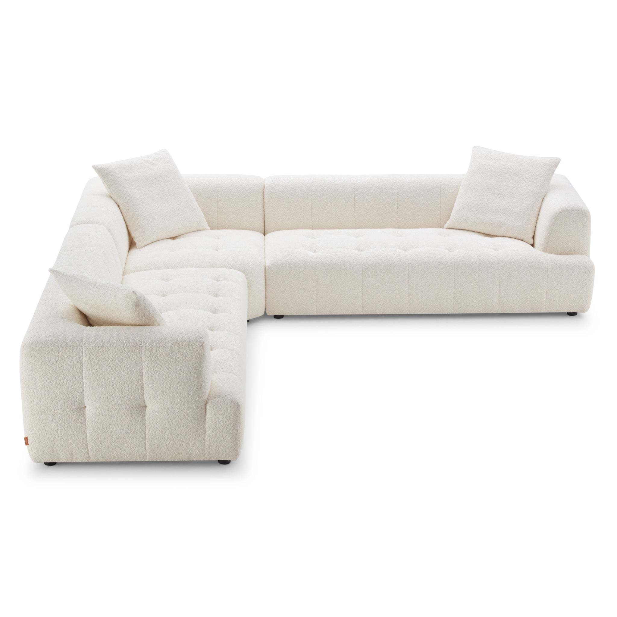 Ivory boucle sectional sofa with tufted cushions, low-profile design, and included throw pillows on a white background.