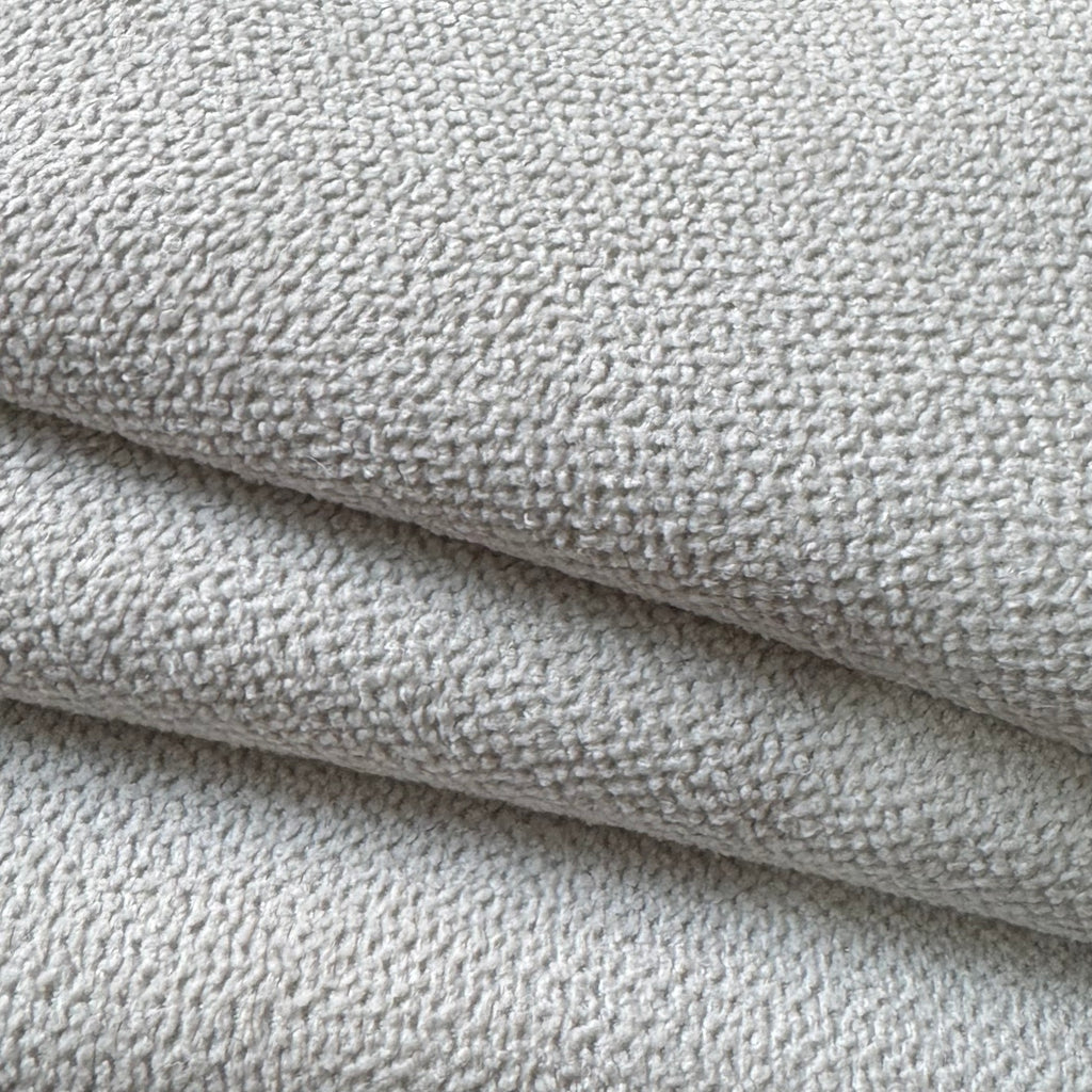 Close-up of the textured white upholstery fabric used in the 99 in. 4-piece L shaped modular sectional sofa couch with ottoman.