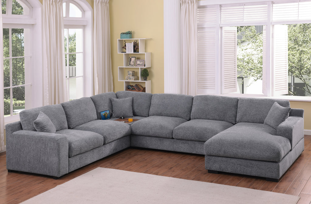 Light gray chenille sectional sofa with right-facing chaise, cupholders, and USB ports in a bright living room. Seats 5 with plush cushions.