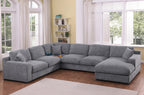 Light gray chenille sectional sofa with right-facing chaise, cupholders, and USB ports in a bright living room. Seats 5 with plush cushions.