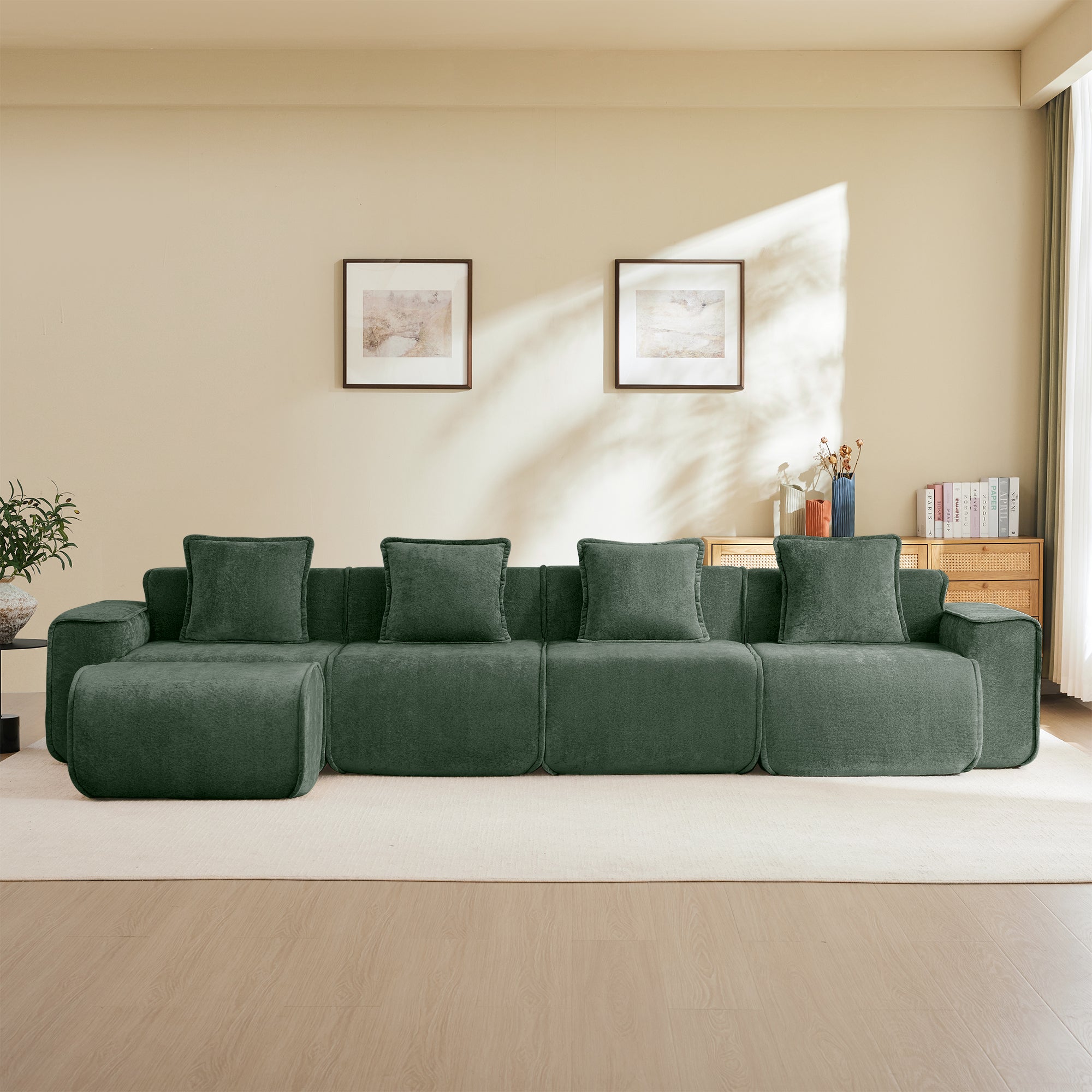 Front view of modular velvet sectional sofa with five pillows and ottoman, showcasing its sleek design and cloud-like comfort.