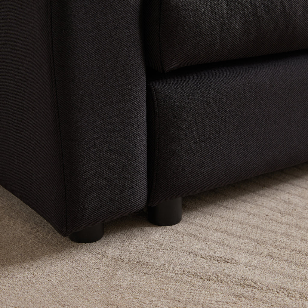 Close-up of sofa leg and fabric texture on modular L-shaped sofa, showing durable construction and modern design.