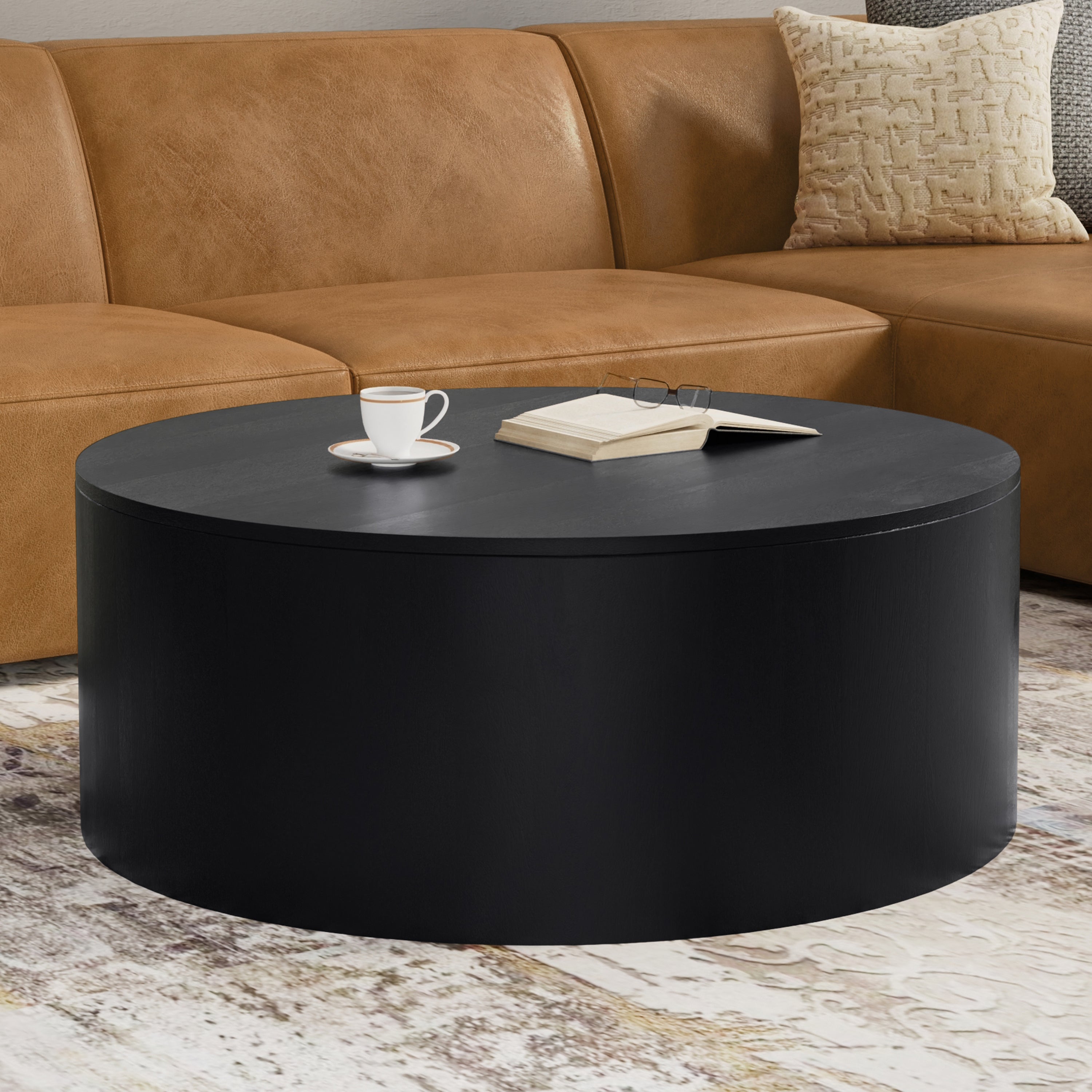 Millbury Drum Coffee Table - Wooden Design in black finish styled in a modern living room with a tan sectional sofa and neutral rug.