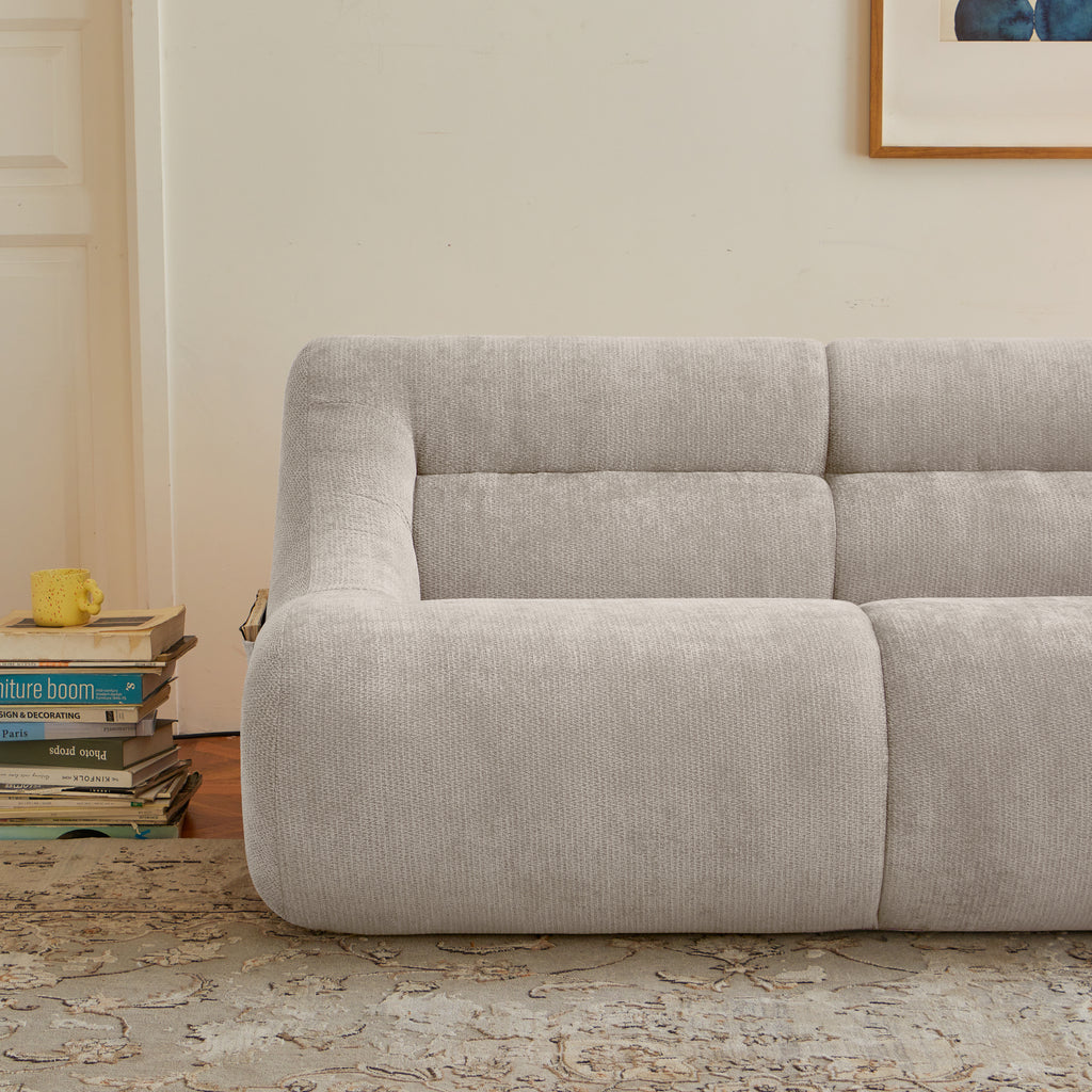 Left-side detail of beige memory foam sofa showing plush chenille texture and ergonomic seating for compact living room comfort.
