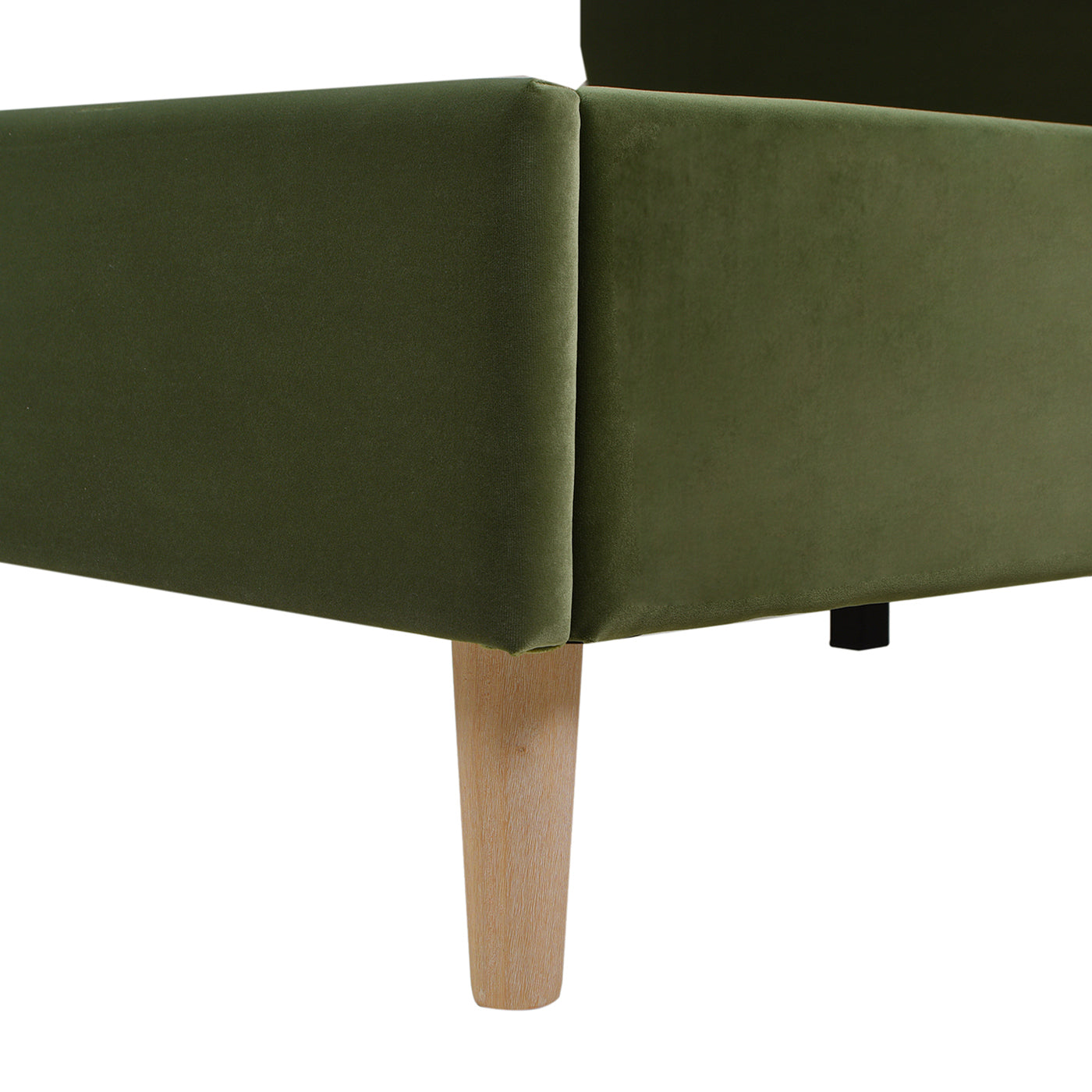 Corner detail of the Stockholm Modern king platform bed with olive green velvet upholstery and tapered wooden leg.