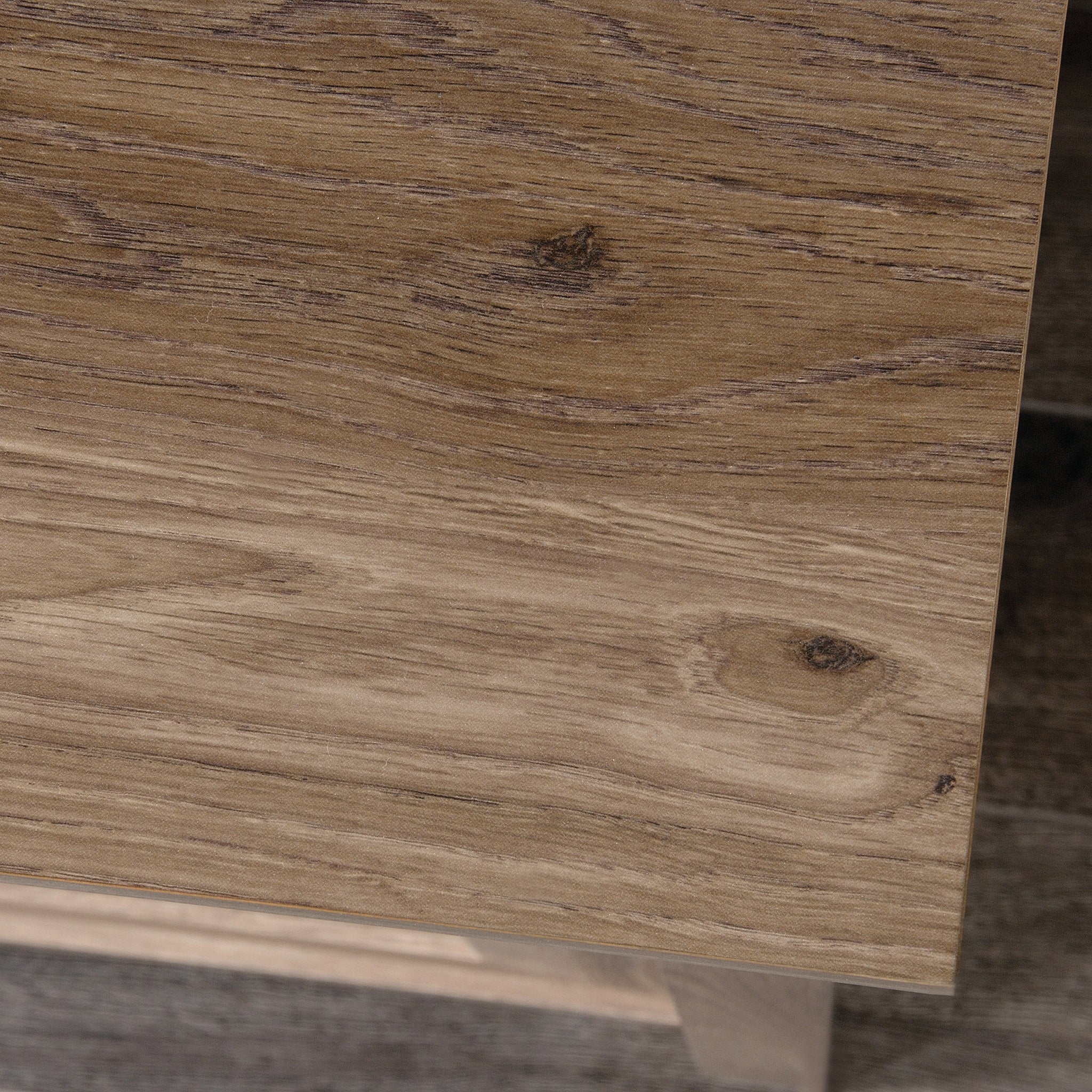 Close-up of the brown dresser's wood grain top surface, showcasing its rustic finish and natural texture.