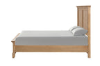 Side profile of farmhouse full size bed in oak finish, highlighting the solid wood frame and clean, rustic lines.