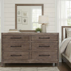 Montrose charcoal brulee dresser with six drawers, sleek black hardware, and rustic wood grain finish in a bedroom.