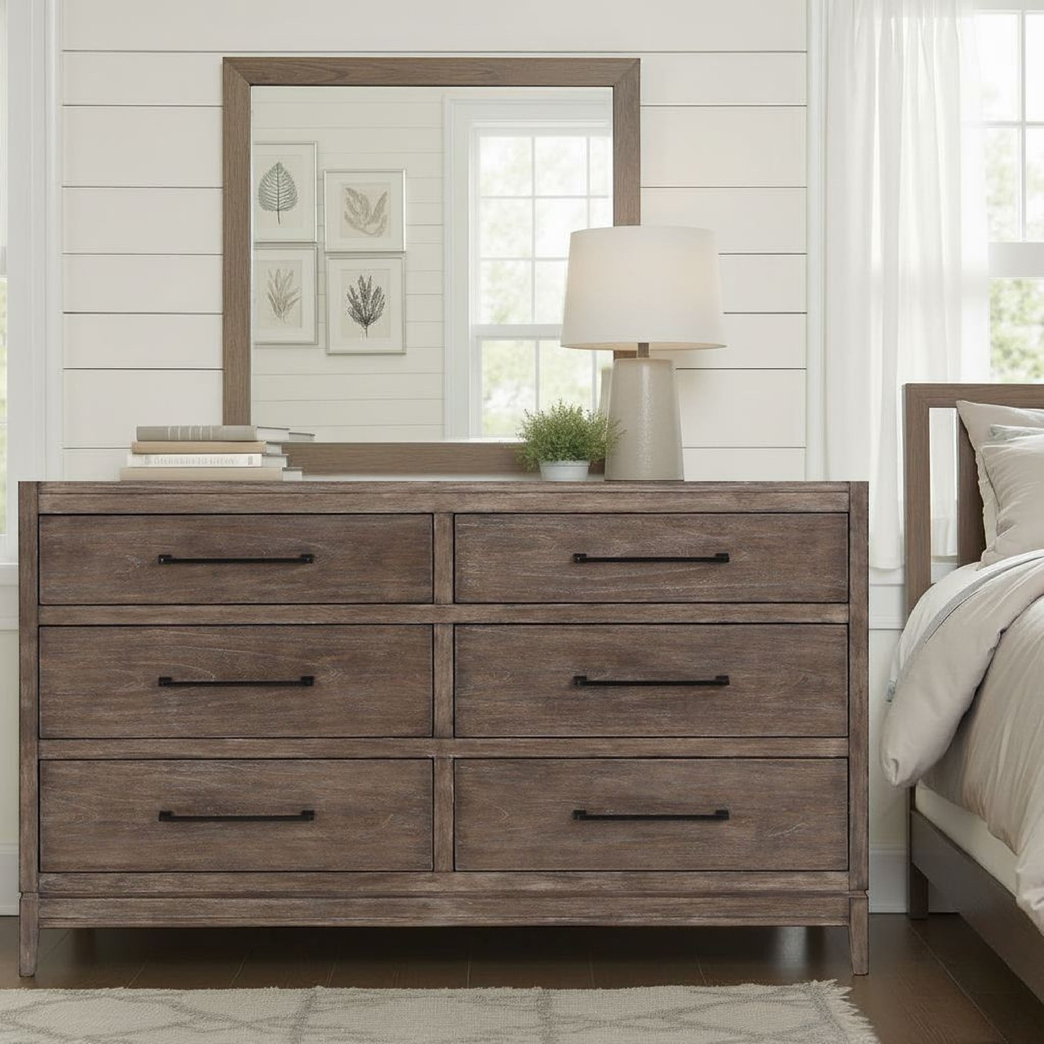 Montrose charcoal brulee dresser with six drawers, sleek black hardware, and rustic wood grain finish in a bedroom.