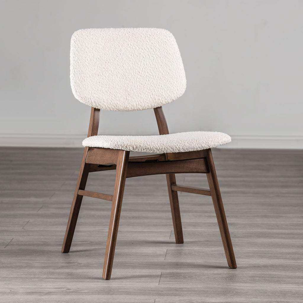 Mid-century dining chair with angled walnut legs and padded beige seat, ideal for modern dining room comfort and style.