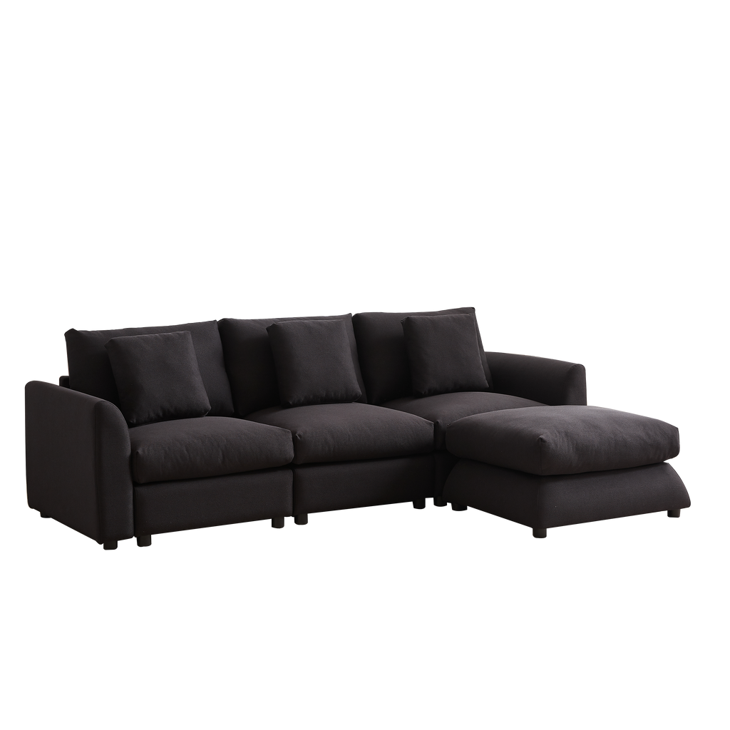 Angled view of modular L-shaped sofa with ottoman, 3 cushions, and 4 pillows in dark upholstery, designed for comfort and modern interiors.