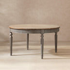 Round reclaimed pine dining table with a natural wood top and fluted antique blue-grey apron and tapered legs.