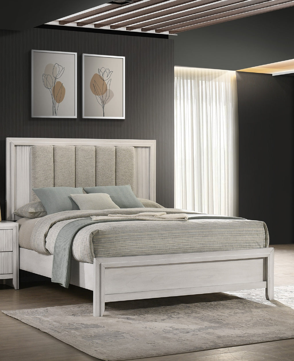 Queen bed with white wood frame and plush upholstered headboard styled in modern bedroom with neutral bedding and soft lighting.