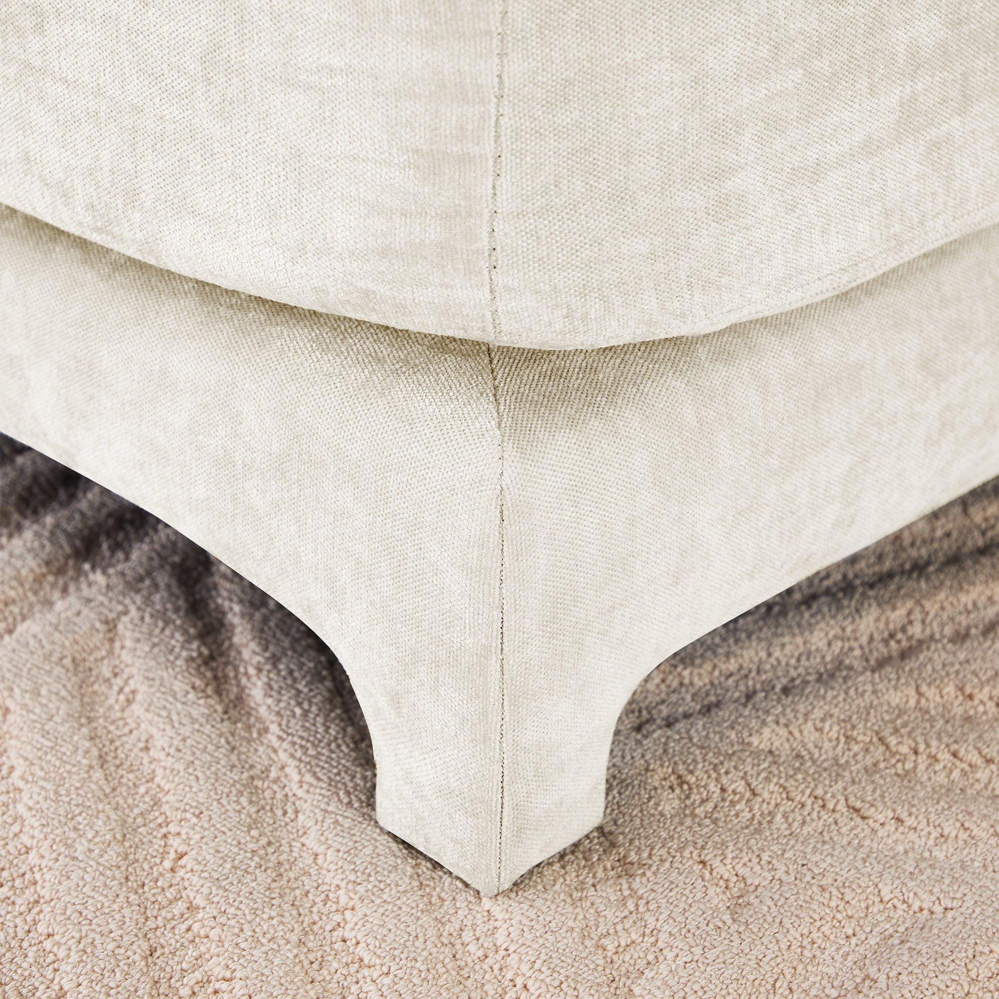 Beige Chenille Four-Seater Sofa with Ottoman Pillow.
