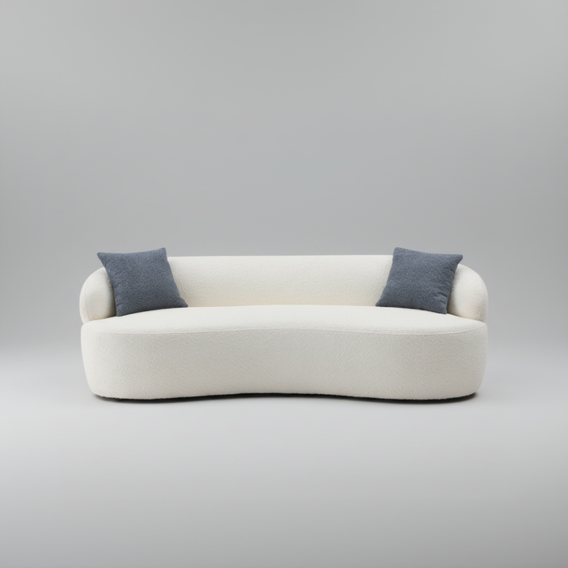 White sofa with two blue cushions on a gray background