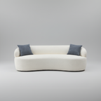White sofa with two blue cushions on a gray background