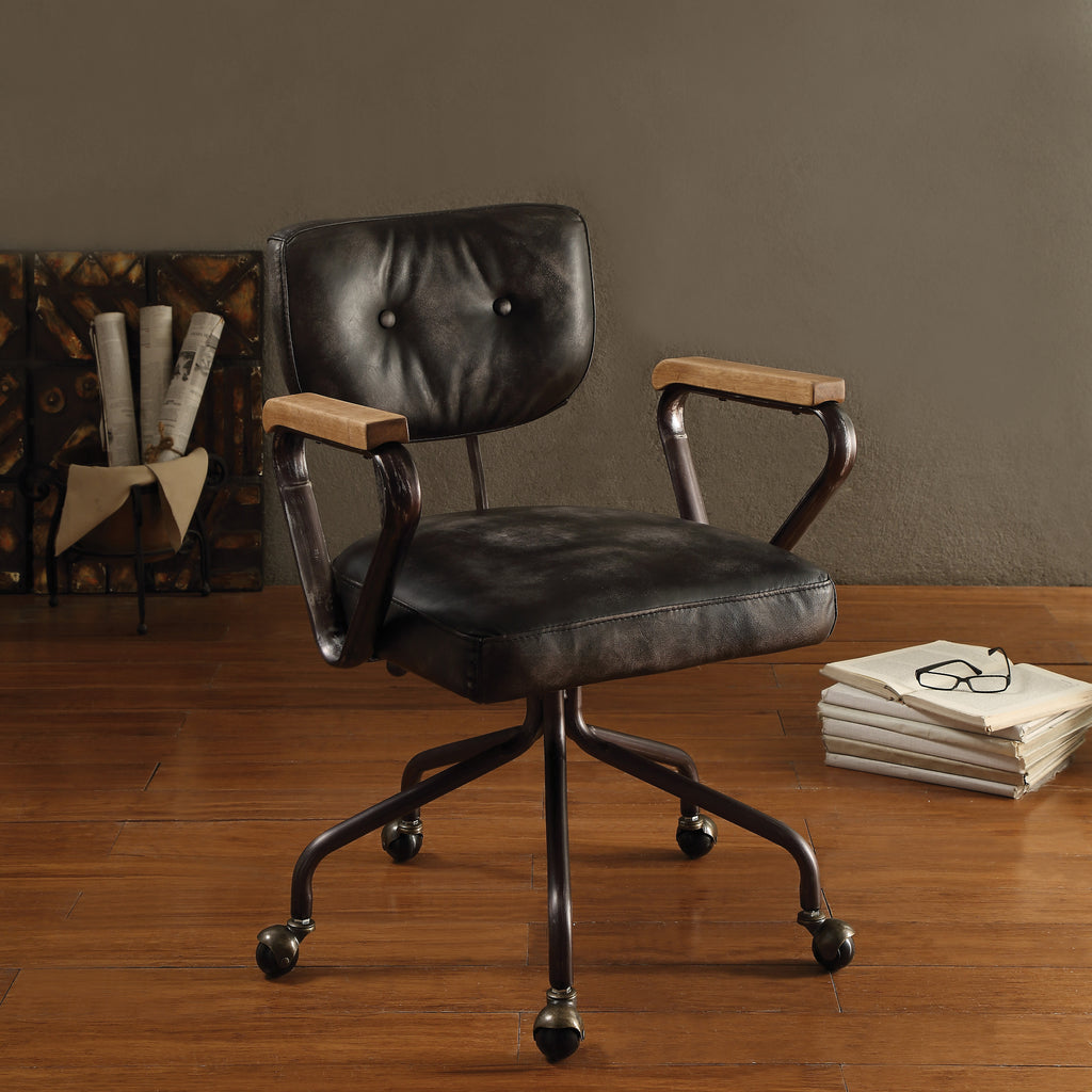 Vintage Black Swivel Office Chair with leather seat, nailhead trim, and wooden armrests in a home office setting. Features tufted back and 5-star base.