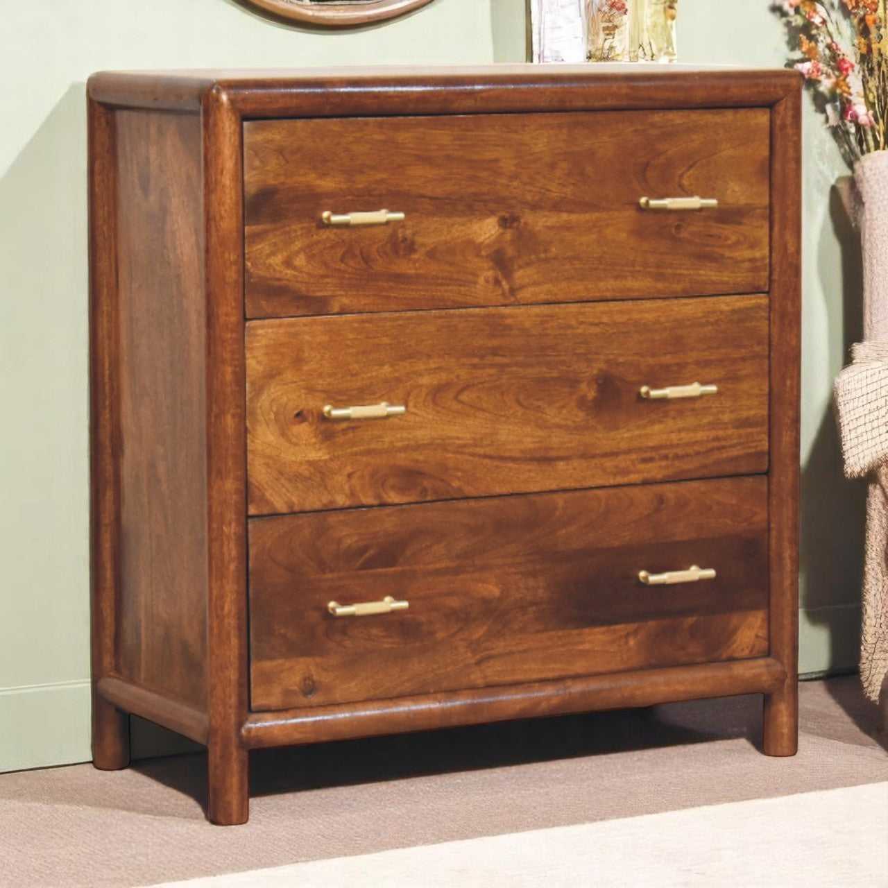Wooden dresser with three drawers in a room setting