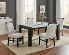 Dining room with a black and white table and chairs in a well-lit room.