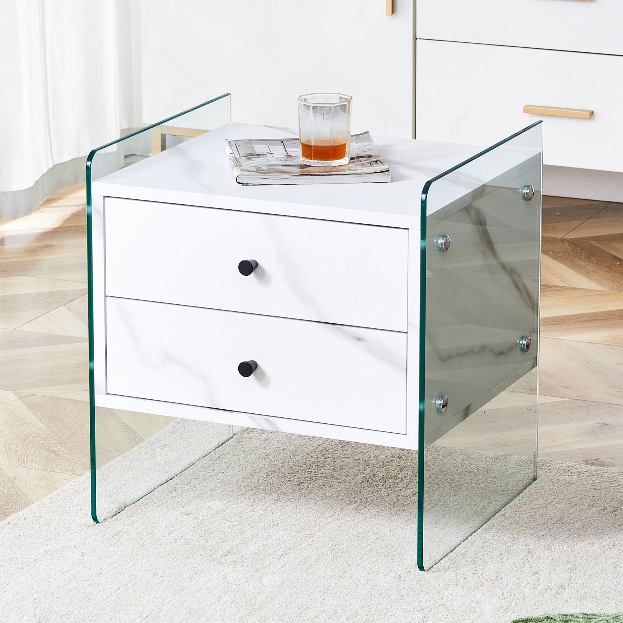 Double-drawer bedside table. The board surface is MDF sticker, and both sides are transparent tempered glass. The design is simple and elegant, with excellent storage functions.