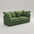 Green sofa with cushions on a gray background