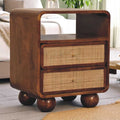 Wooden side table with wicker drawers in a living room setting