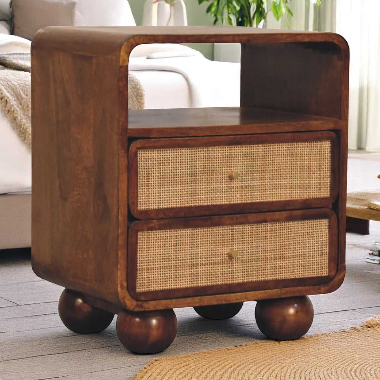 Wooden side table with wicker drawers in a living room setting
