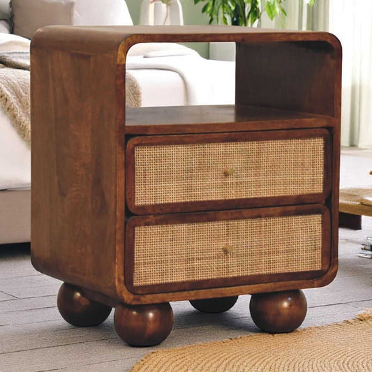 Wooden side table with wicker drawers in a living room setting
