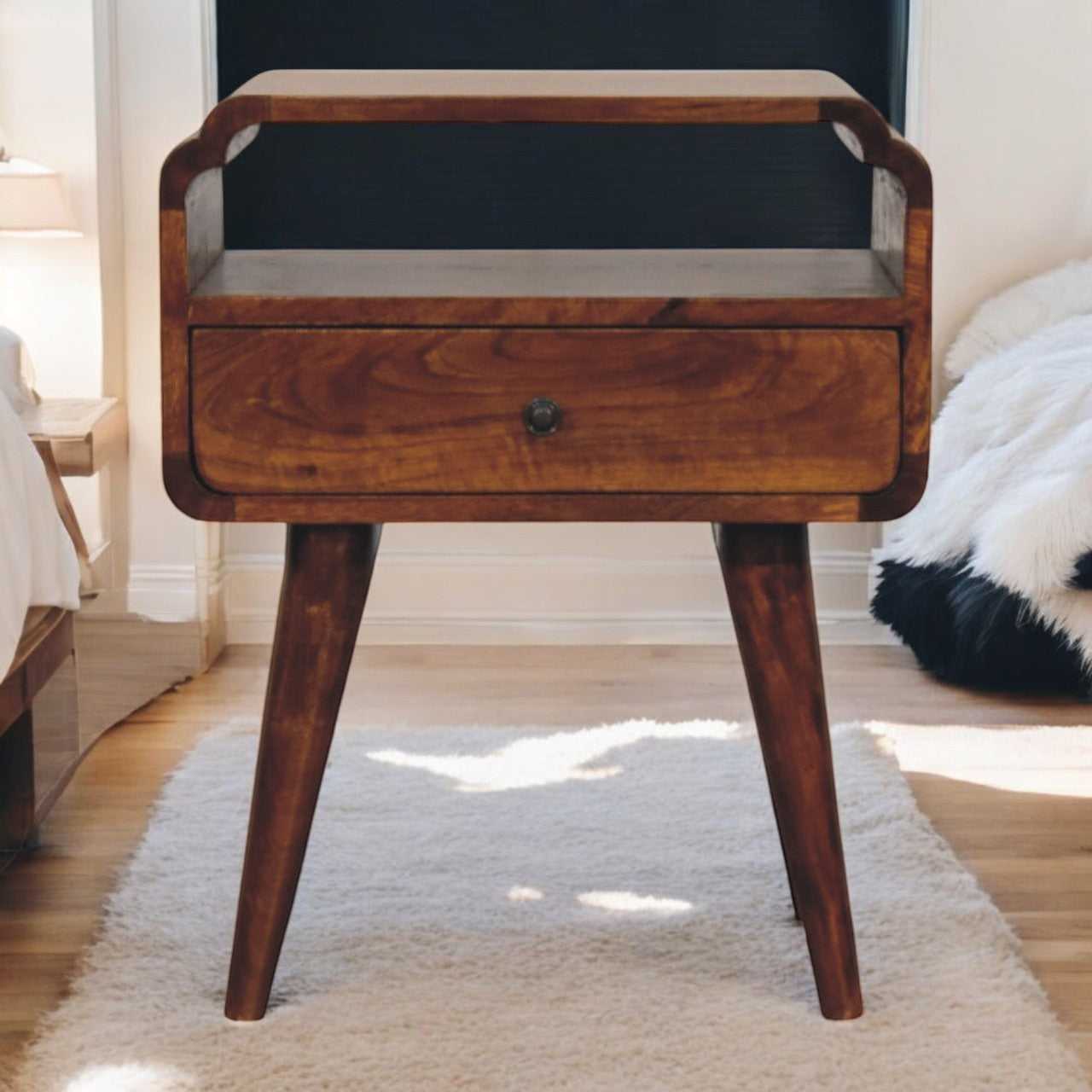 Wooden side table with a drawer in a room setting