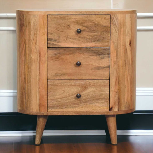 Wooden cabinet with three drawers against a neutral wall.