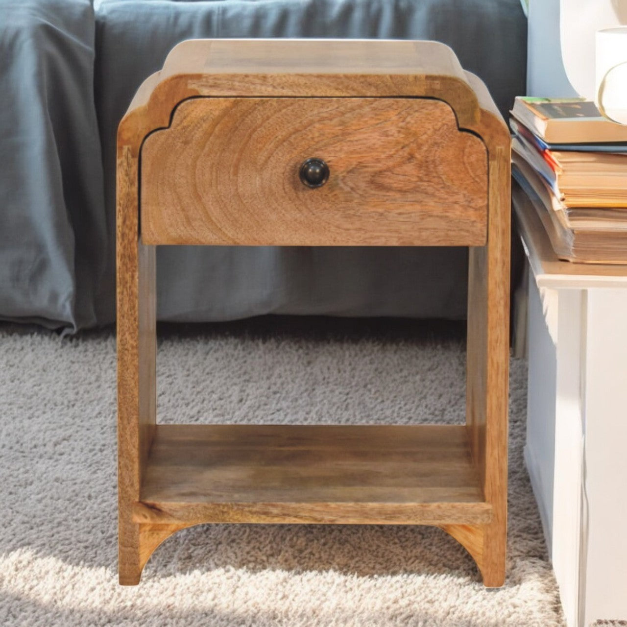 Wooden nightstand with a drawer in a bedroom setting