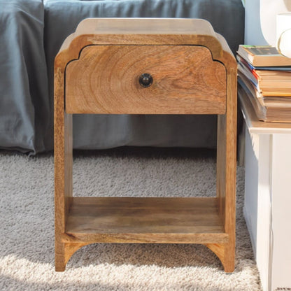 Wooden nightstand with a drawer in a bedroom setting
