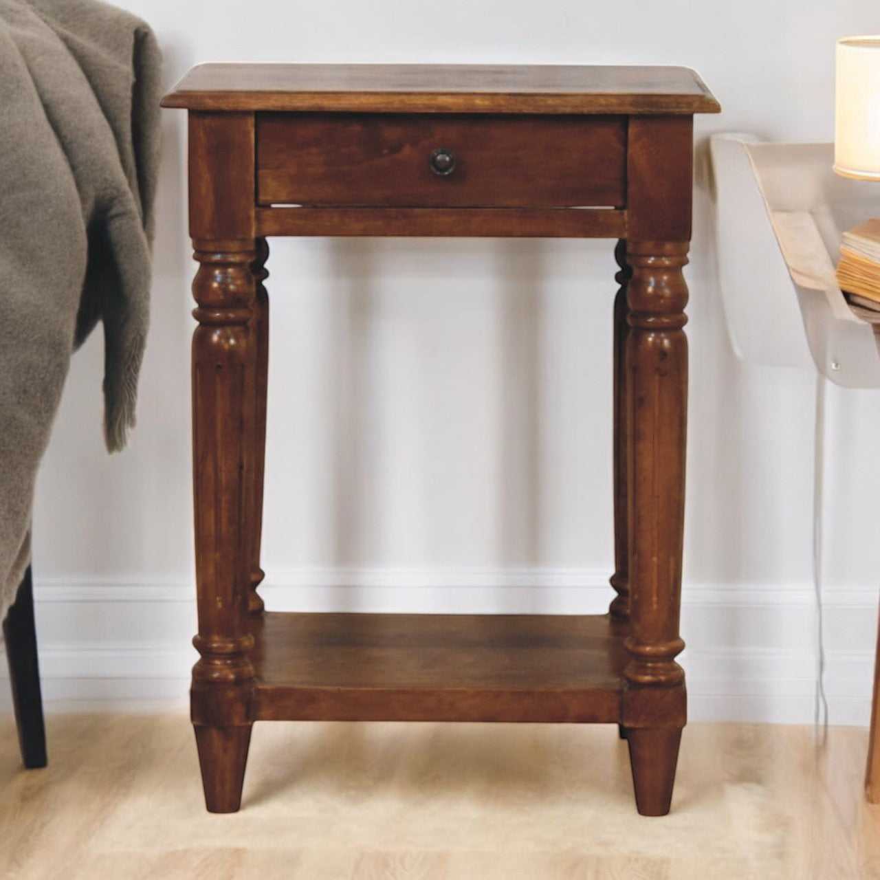 Wooden side table with a drawer in a room setting