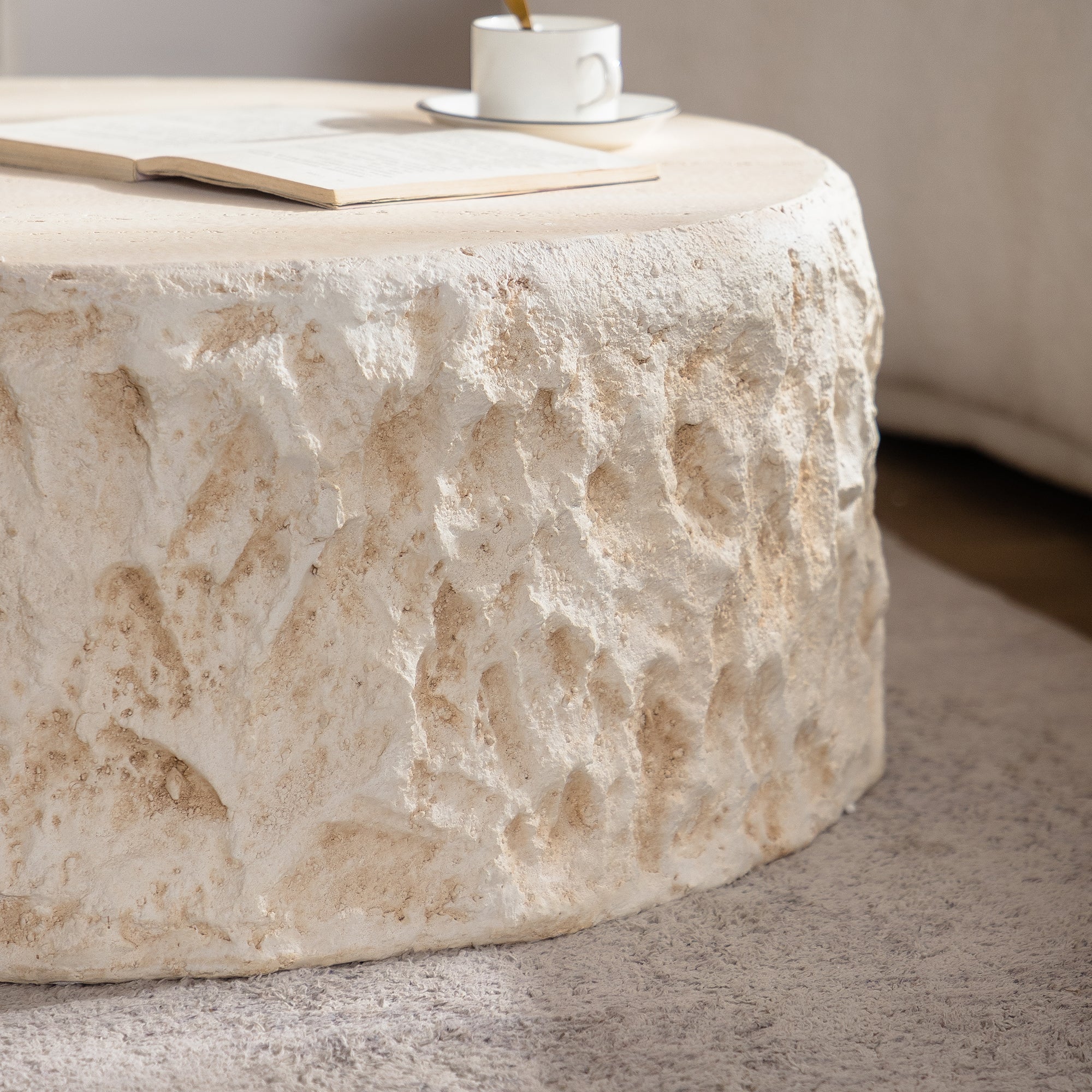 Close-up of the Mid-Century MgO Coffee Table's rugged faux stone finish, highlighting its durable and natural stone-like texture.
