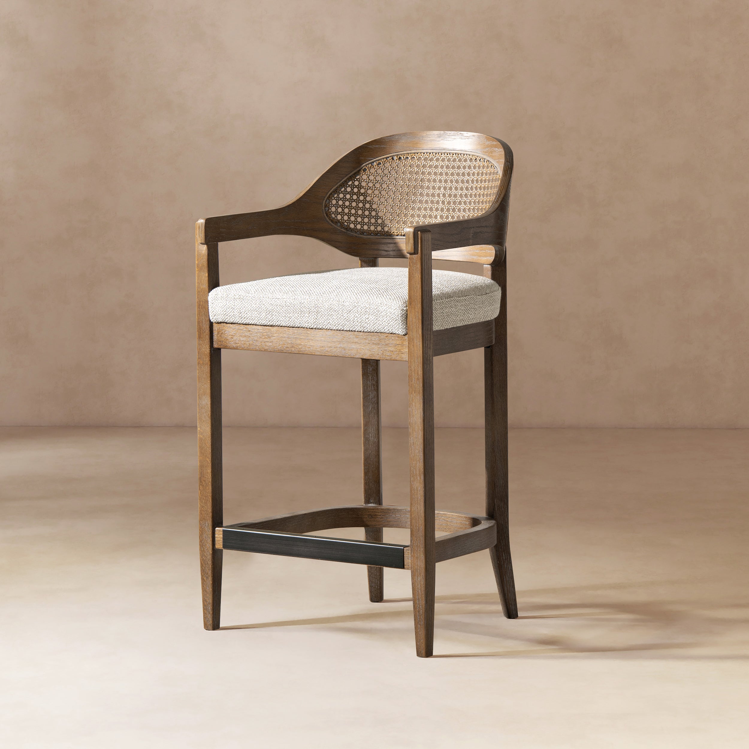 Mid-Century Stool - Cane Back Modern with oak frame, curved arms, and brass footrest. Features a woven wicker back and cushioned seat.