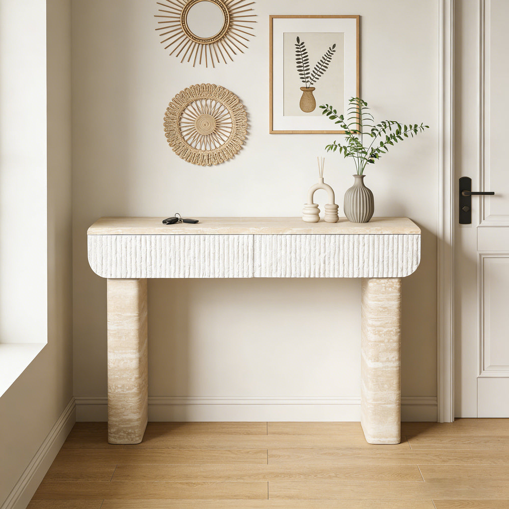 Modern beige console table with textured white drawers and sturdy stone-look base, set in a minimalist entryway.