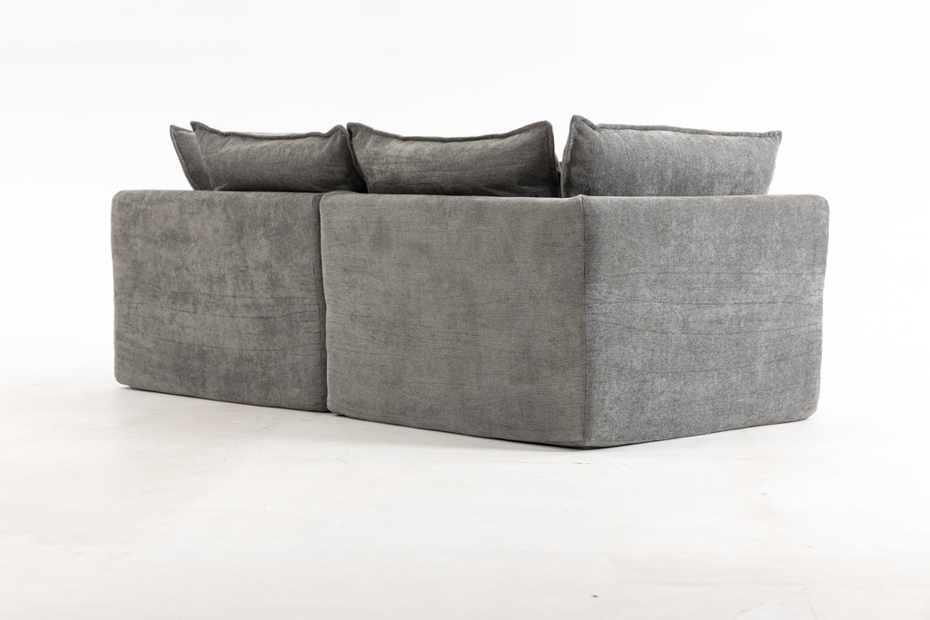 Back view of the oversized modular sectional couch with clean lines and smooth grey velvet upholstery.