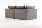 Back view of the oversized modular sectional couch with clean lines and smooth grey velvet upholstery.