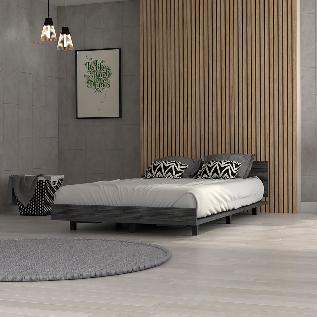 Nimmo twin bed frame in smokey oak with a low-profile, modern minimalist design set against a wood slat wall.