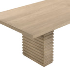 Close-up of 95 inch light ash dining table showing smooth wood grain top and sculpted pedestal base detail.