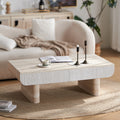 Mid-century modern coffee table with a faux marble top, white fluted drawer, and sturdy beige stone-look block legs.
