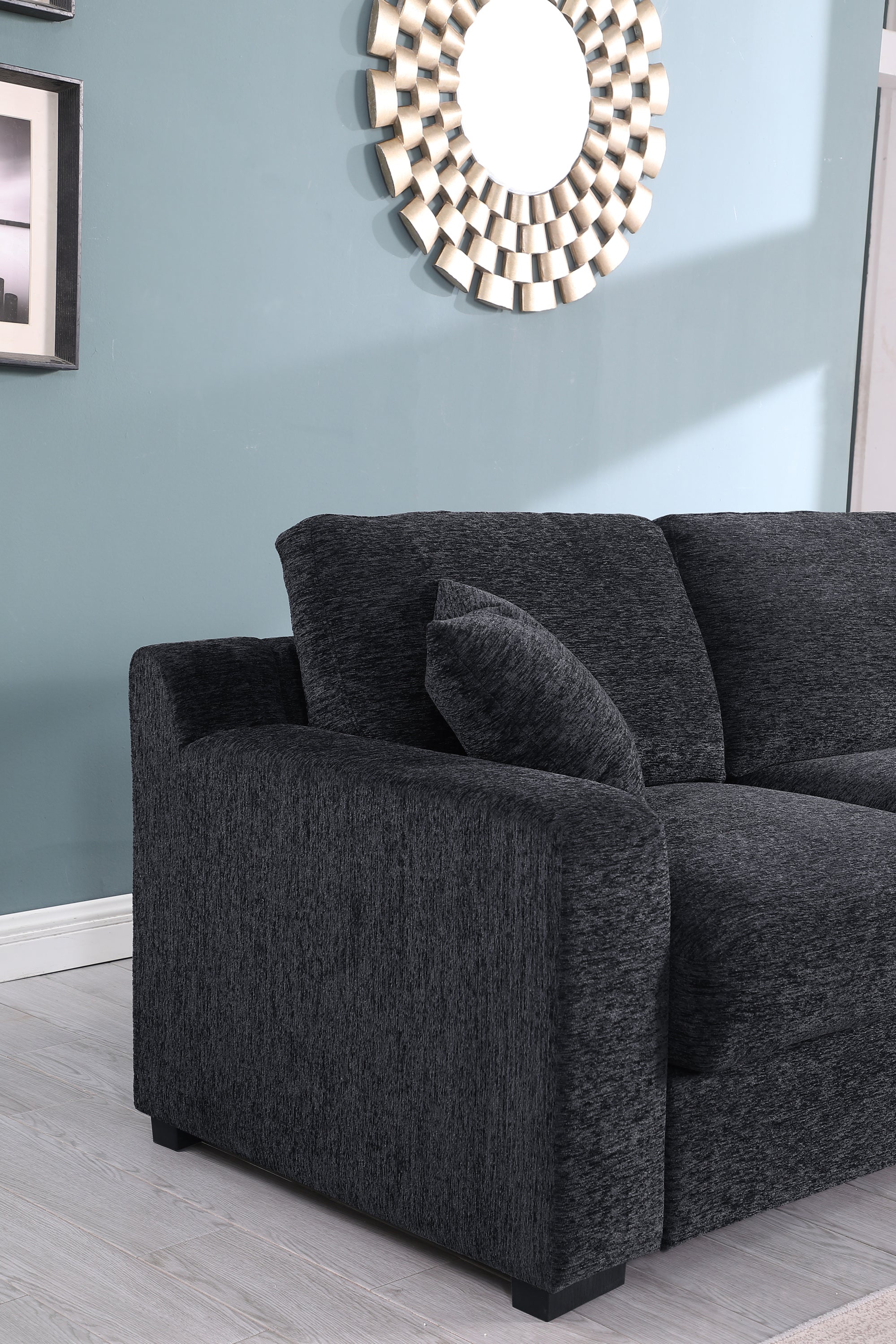Armrest and cushion detail of Celine sectional sofa in dark gray. Features plush padding and contemporary design.