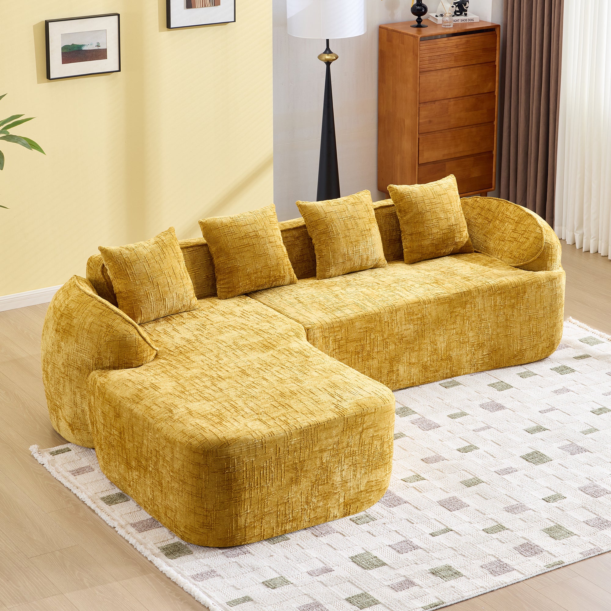 Yellow chenille L-shaped sofa with five cushions, ideal for comfort living in modern interiors. Features plush texture and curved armrests.