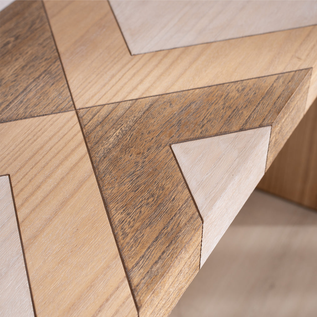 Detailed view of chevron wood inlay on modern console table, emphasizing texture and multi-tone wood finish.