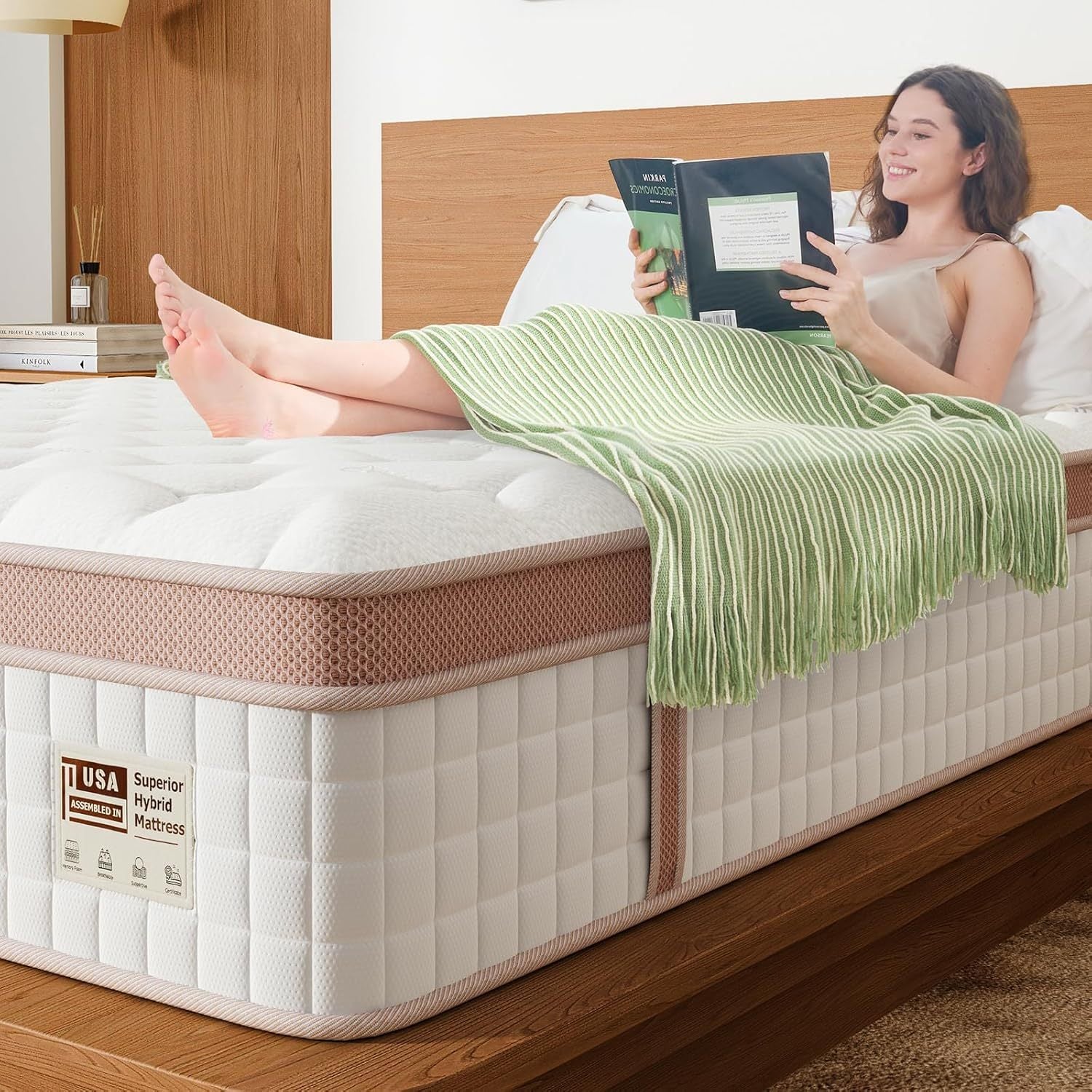 Woman reading on firm King Size Hybrid Mattress with gel memory foam and edge support, showcasing comfort and motion isolation.