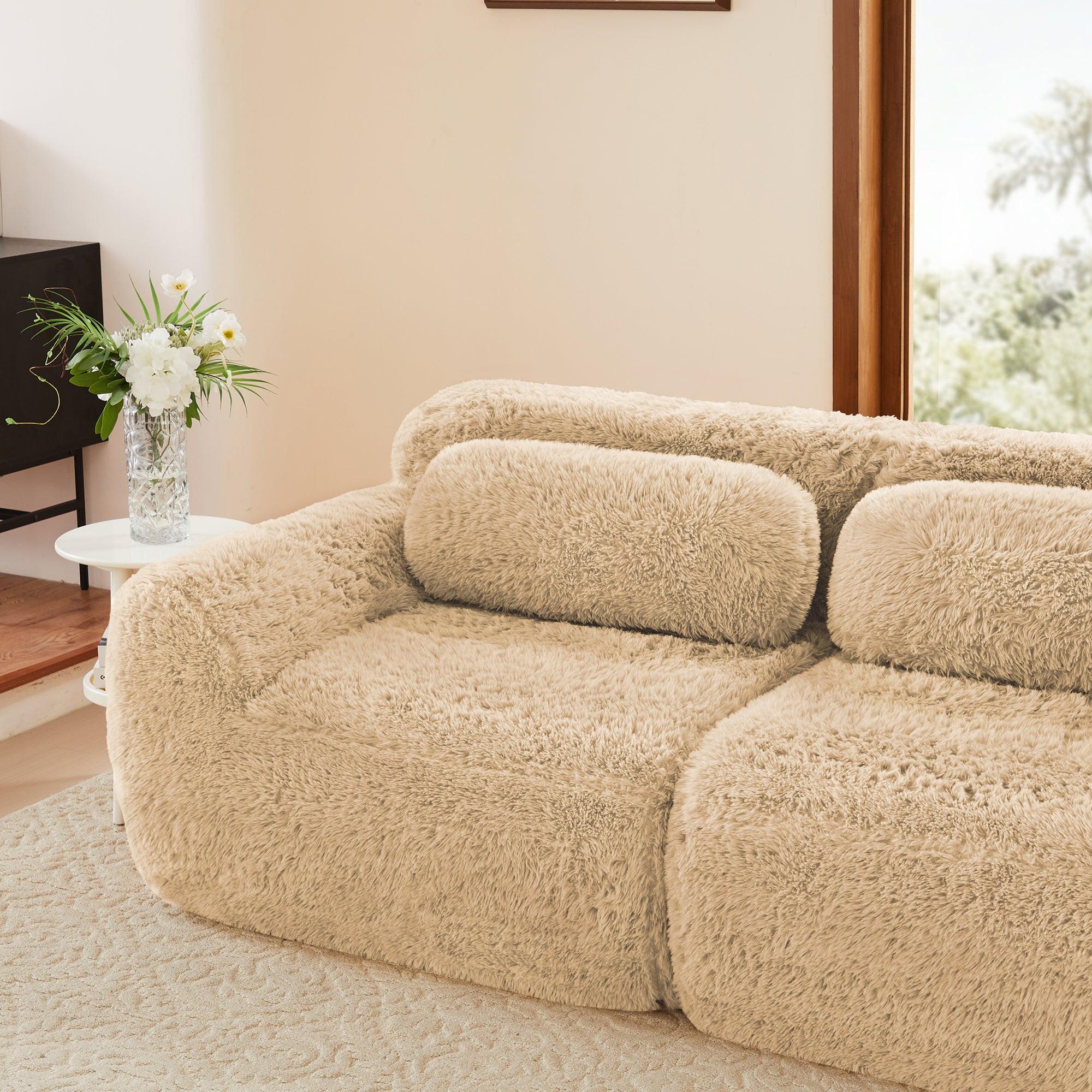 Left side view of modular sectional sofa with plush fabric and pillow, styled in a contemporary living room interior.