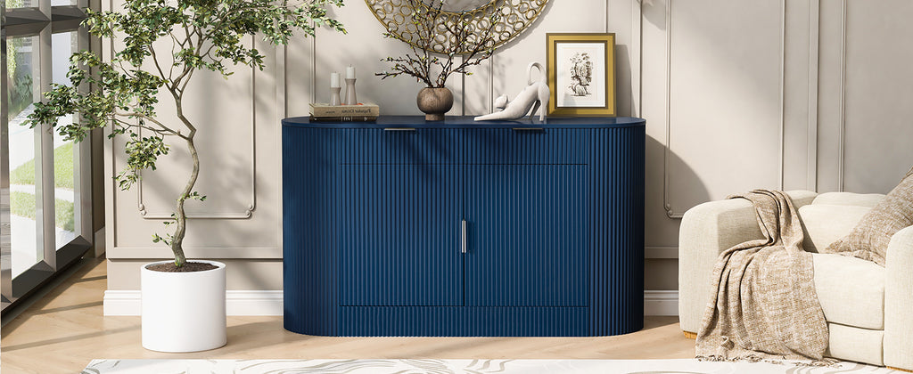 Modern navy blue MDF storage cabinet with curved doors styled in a bright living room next to a potted plant and armchair.